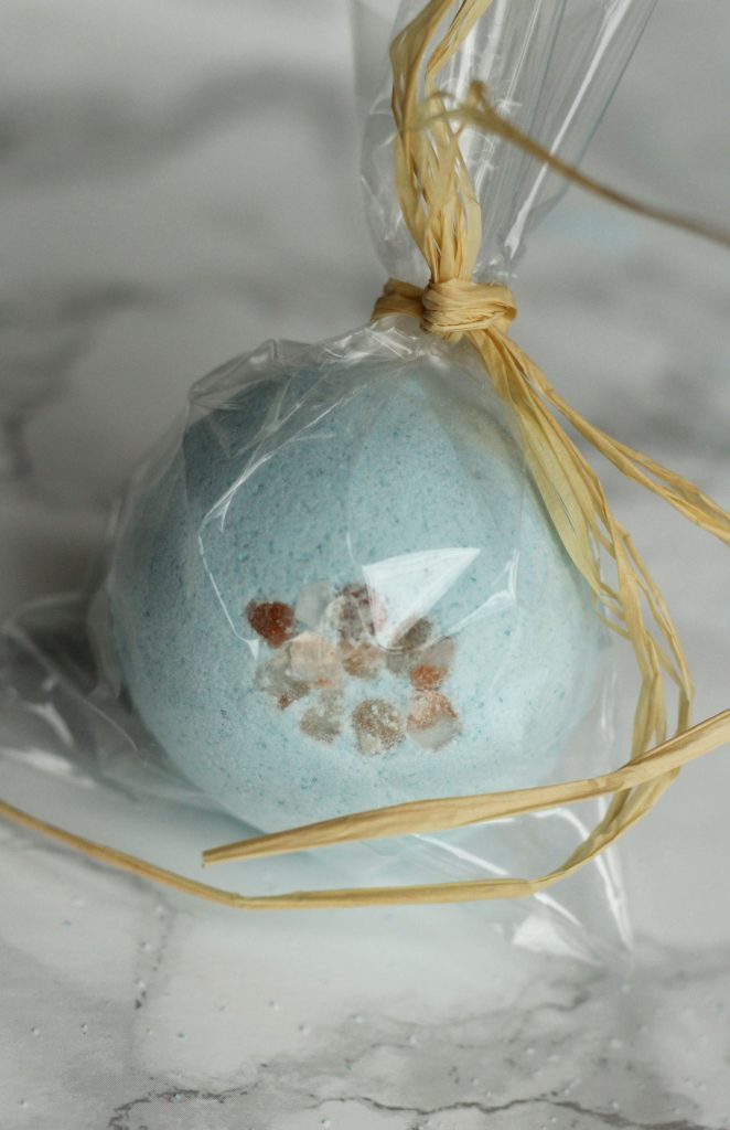 blue round bath bomb in clear packaging