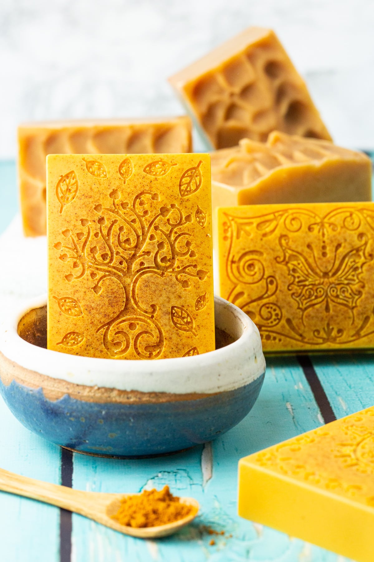 turmeric soap bars in soap dish and on towel.