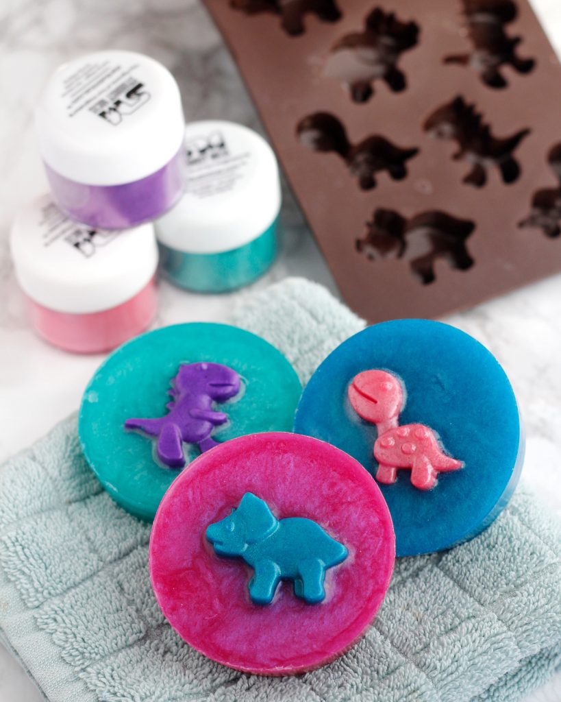 three round colorful dinosaur soaps