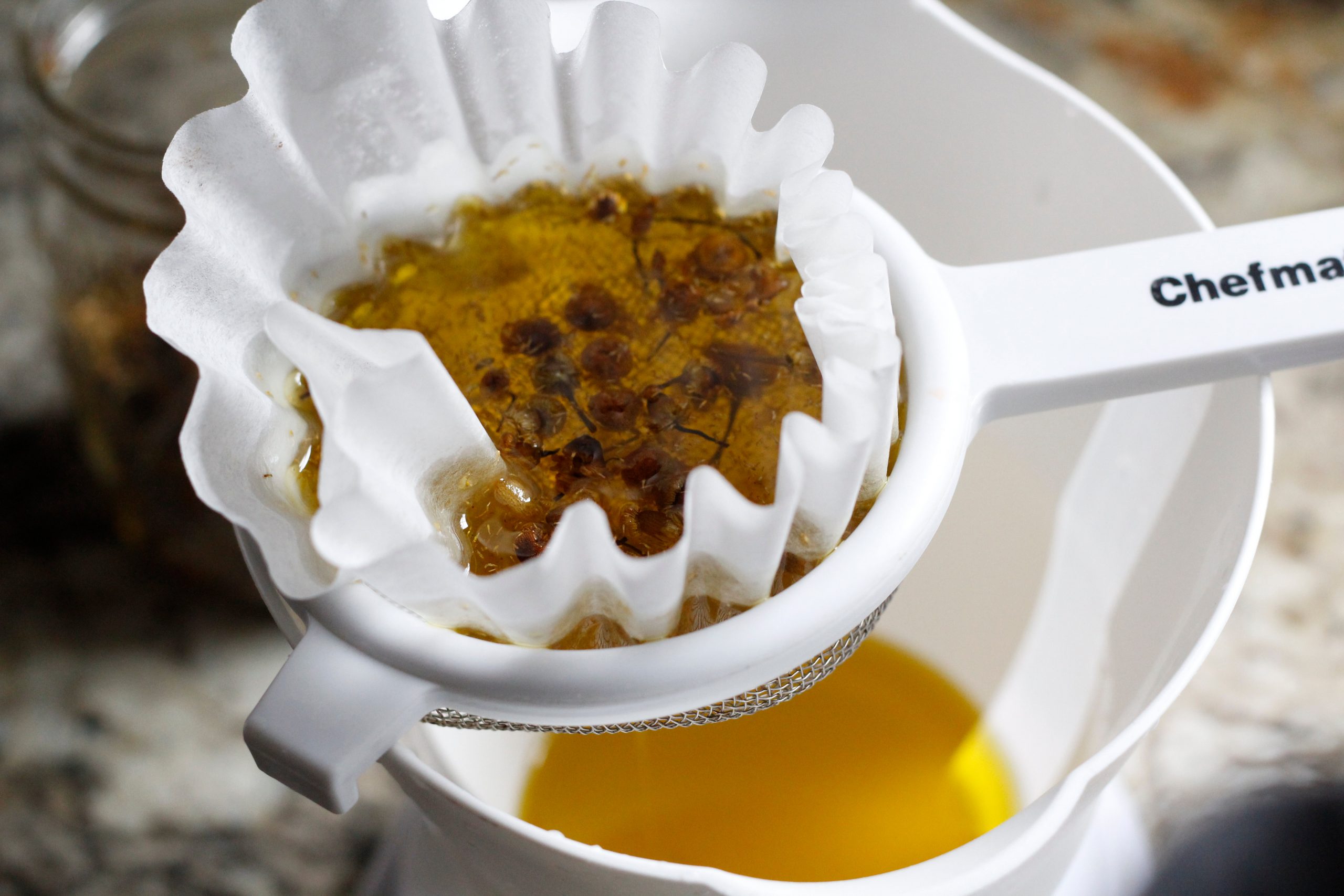 straining chamomile from olive oil