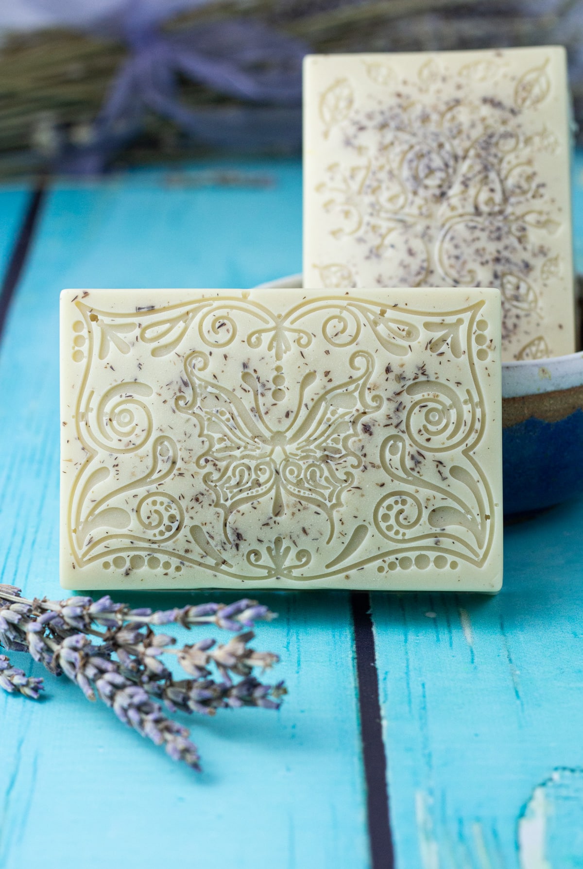 two lavender soap bars with floral design.
