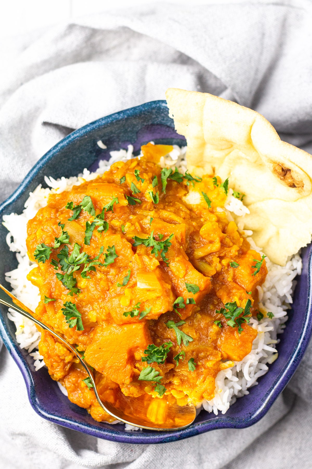 sweet potato curry with piece of naan bread.