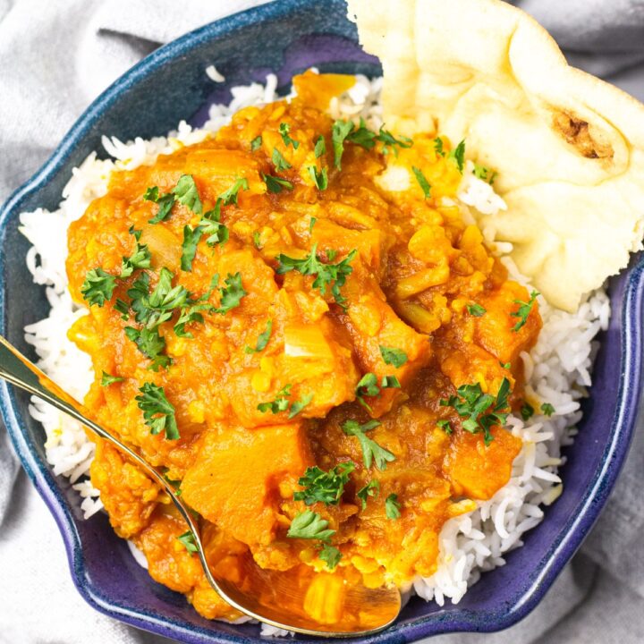 sweet potato curry in blue bowl over rice