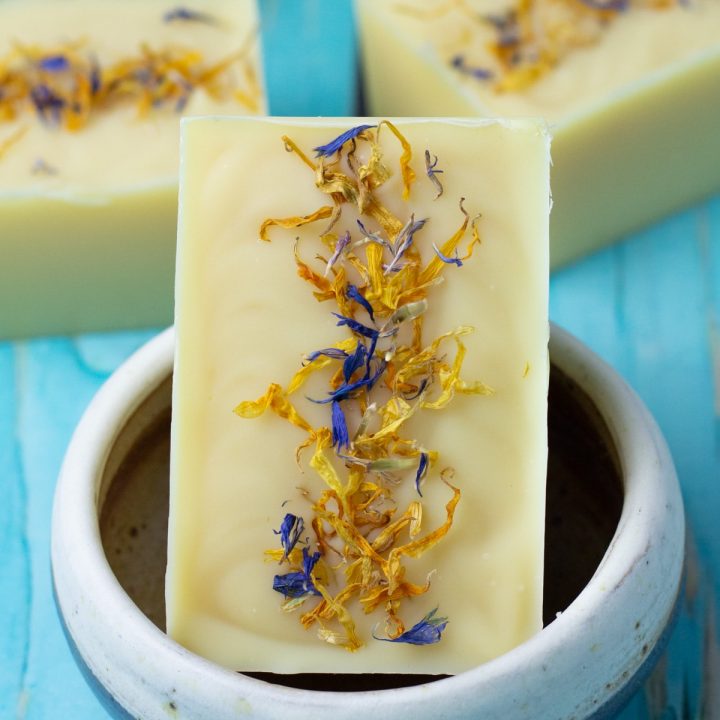 bar of soap with calendula on top.