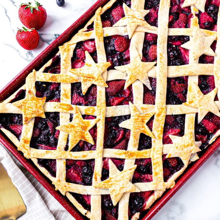 berry slab pie on baking sheet decorated with stars.
