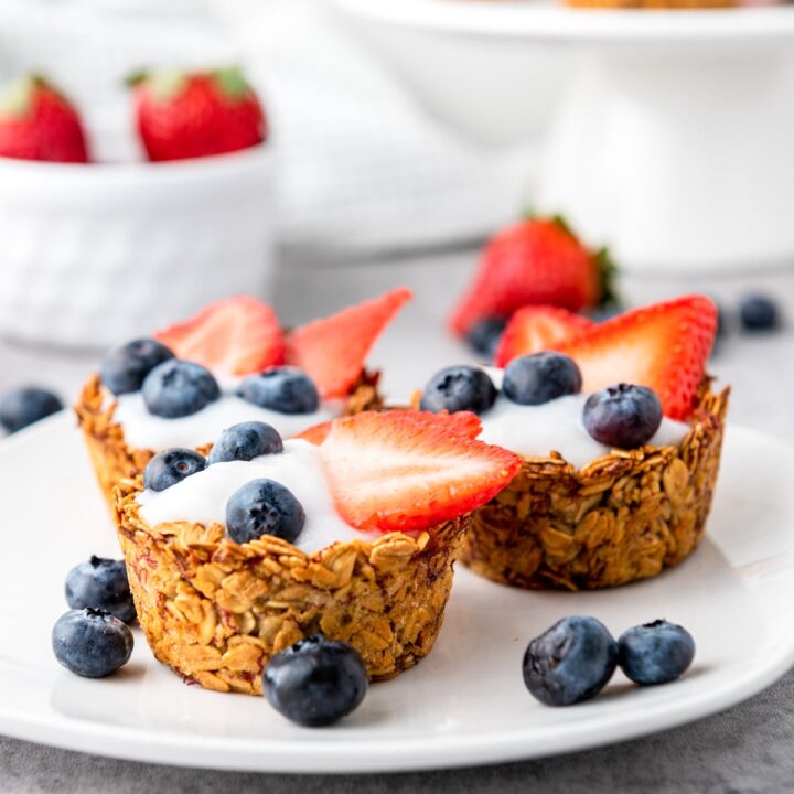 granola cups filled with yogurt, blueberries, and strawberries.